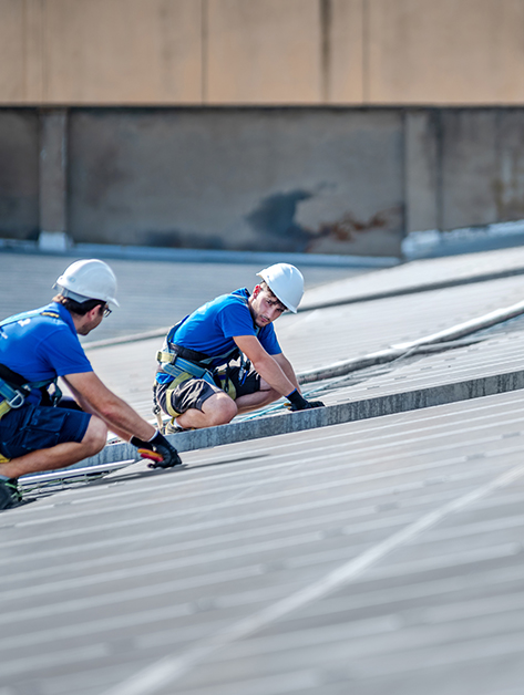 Roofer completing a epdm roof inspection in Rochester, NY