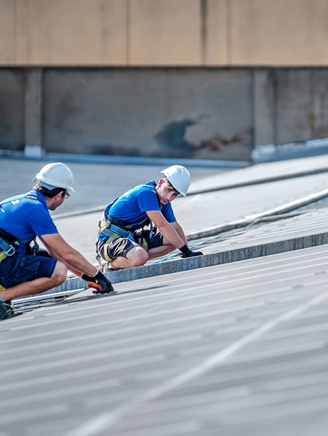 Roofer completing a epdm roof inspection in Rochester, NY