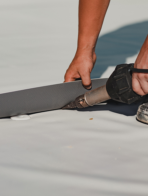 our roofer completing pvc roof maintenance in Rochester, NY